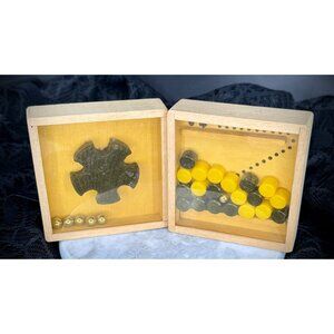 logic puzzles housed in small wooden display boxes